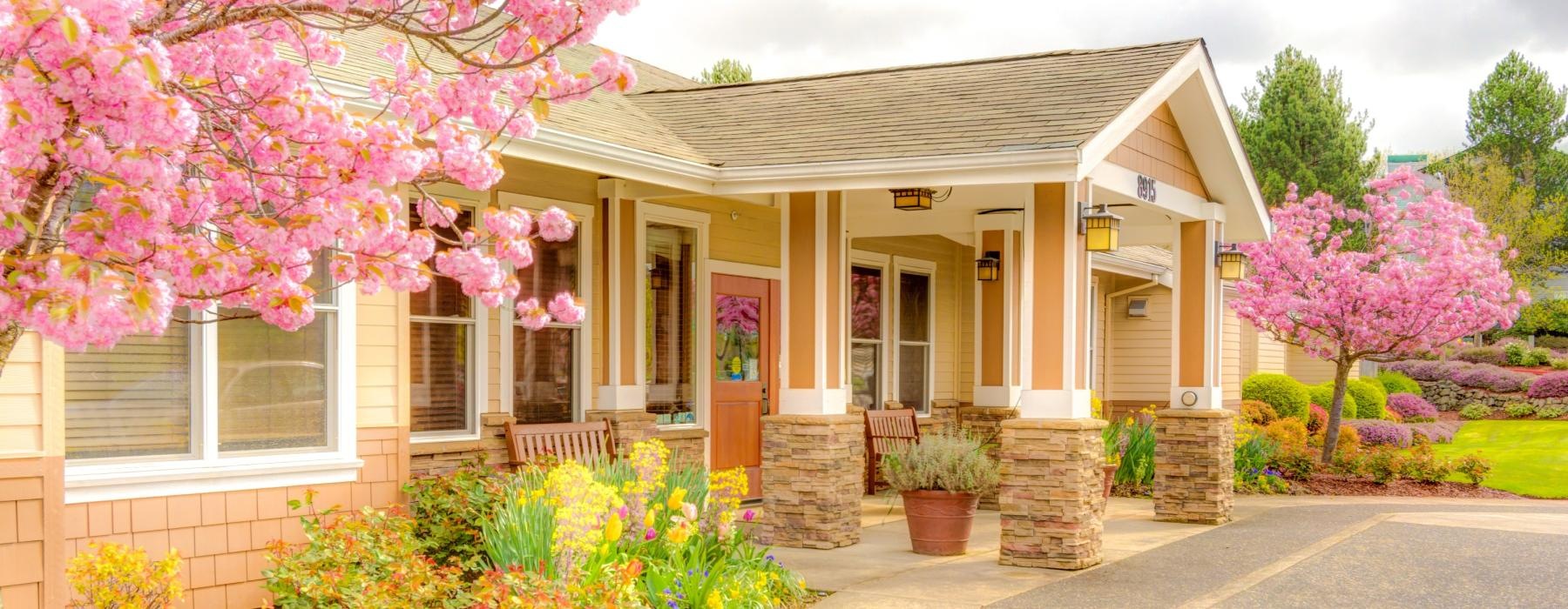 a building with a front yard and beautiful trees