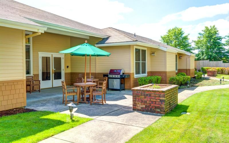 a house with a patio and a table and chairs