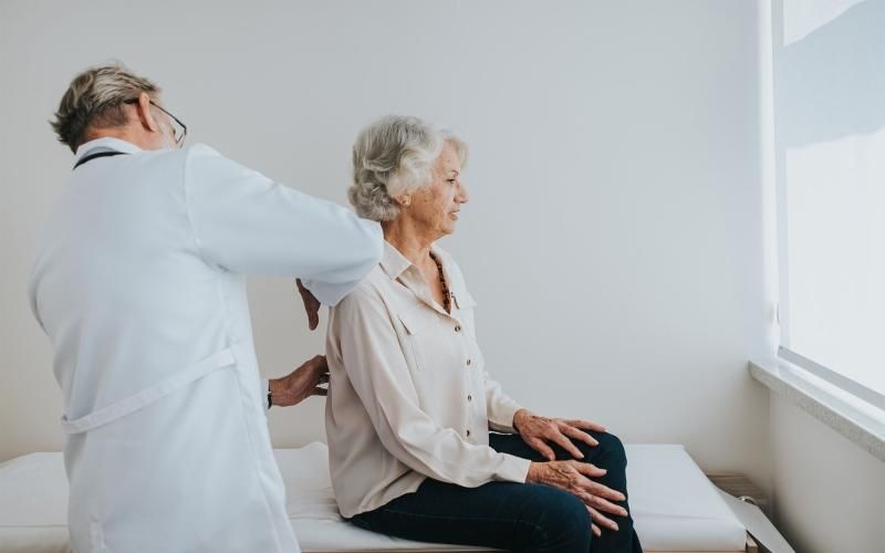 a doctor checking on an older woman